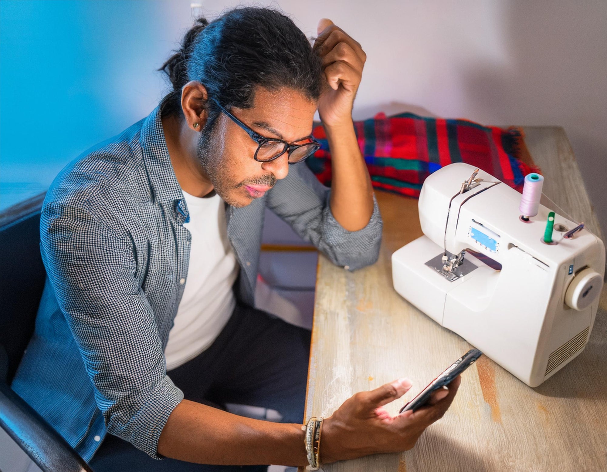 Man Looking for Sewing Machine Help on His Phone